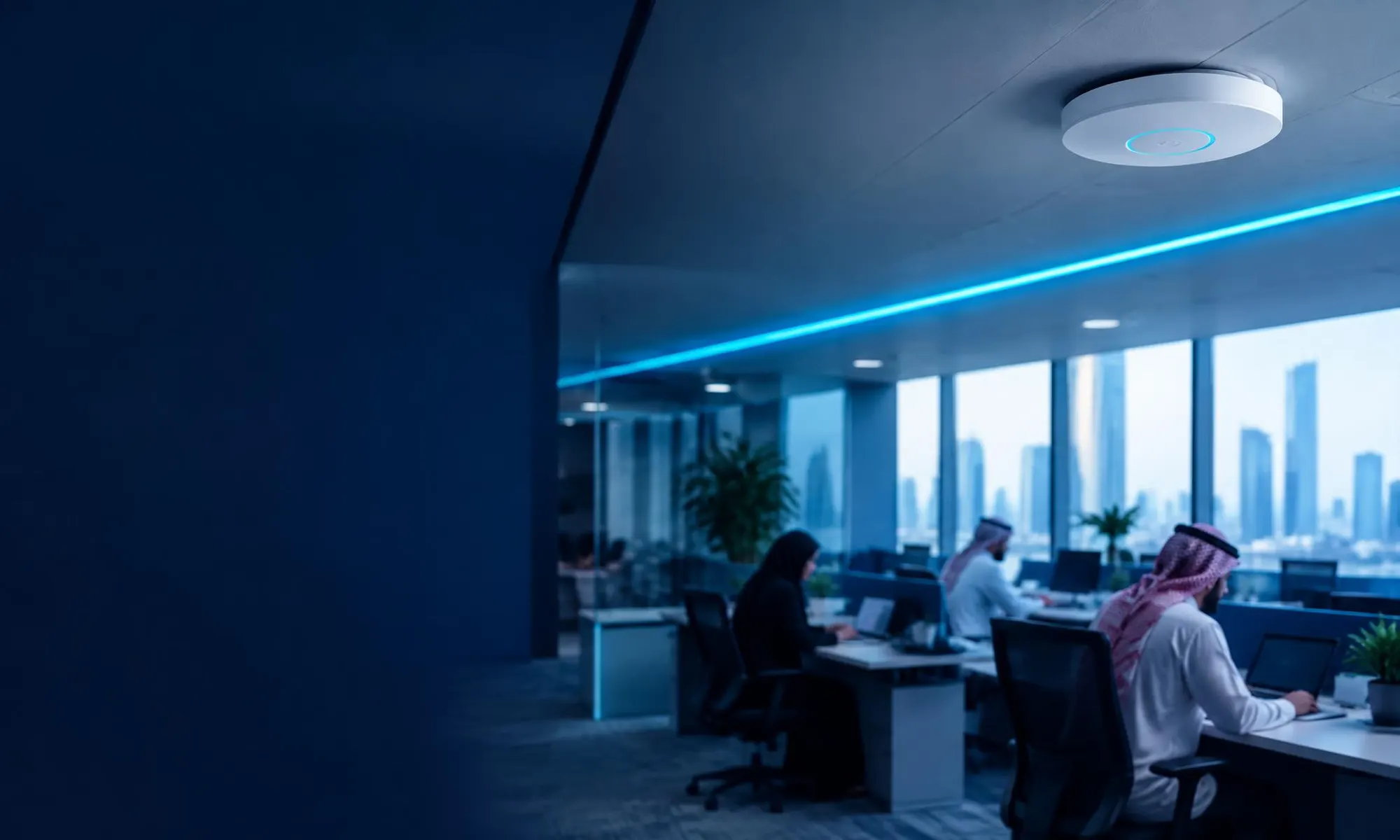 A ceiling wireless access point above employees working in a branch office